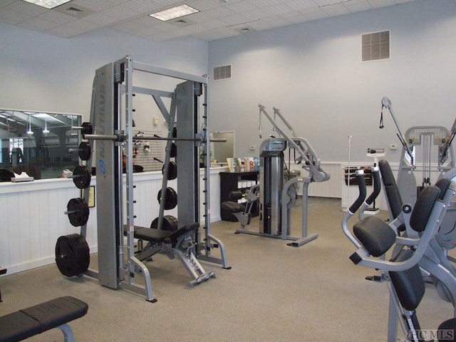 exercise room featuring a paneled ceiling