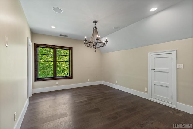 unfurnished room with vaulted ceiling, an inviting chandelier, and dark hardwood / wood-style flooring