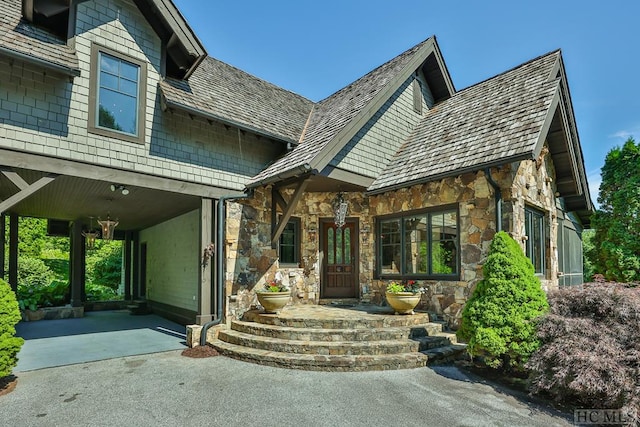 view of exterior entry with covered porch