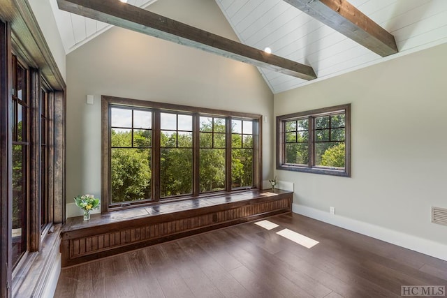 unfurnished sunroom with vaulted ceiling with beams