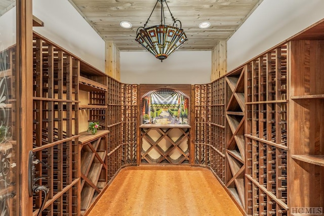 wine room with hardwood / wood-style flooring and wooden ceiling