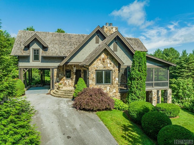 craftsman inspired home featuring a carport and a sunroom