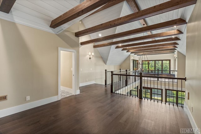 interior space with lofted ceiling with beams and dark hardwood / wood-style floors