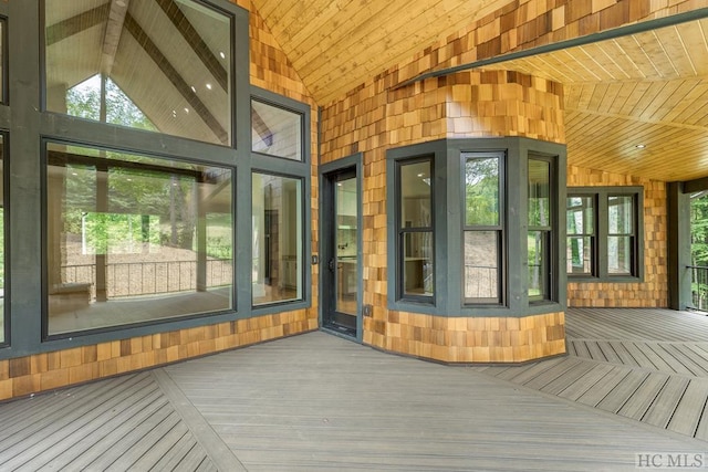 unfurnished sunroom with vaulted ceiling and wooden ceiling