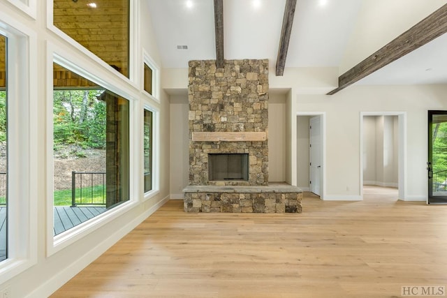 unfurnished living room featuring a fireplace, plenty of natural light, and light hardwood / wood-style flooring