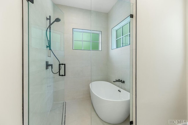 bathroom featuring independent shower and bath and tile patterned floors