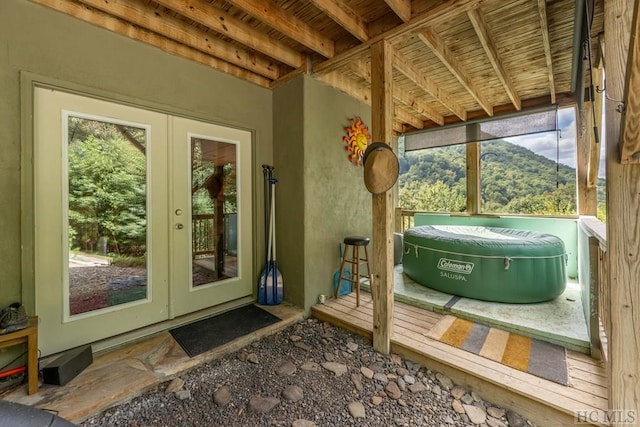 sunroom featuring a mountain view and french doors