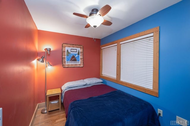 bedroom with ceiling fan and light hardwood / wood-style floors