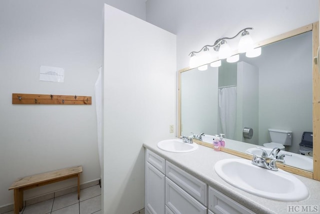 bathroom featuring tile patterned flooring, vanity, and toilet