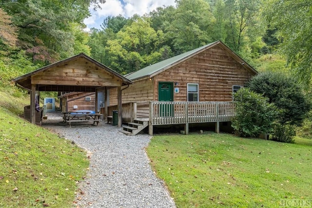 view of front of house with a front lawn and a wooden deck