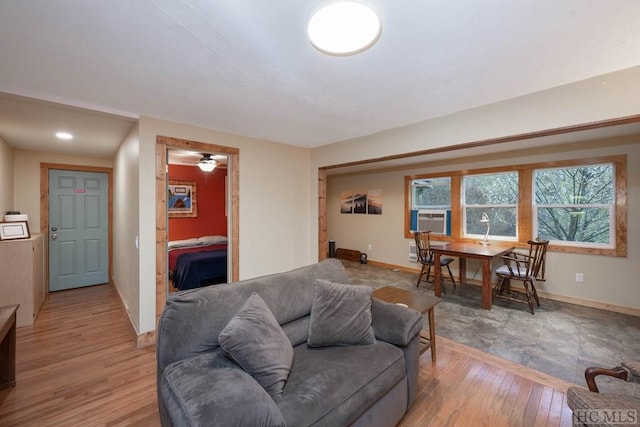 living room with cooling unit and light hardwood / wood-style flooring