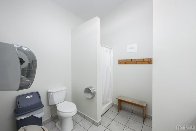 bathroom with walk in shower, tile patterned floors, and toilet