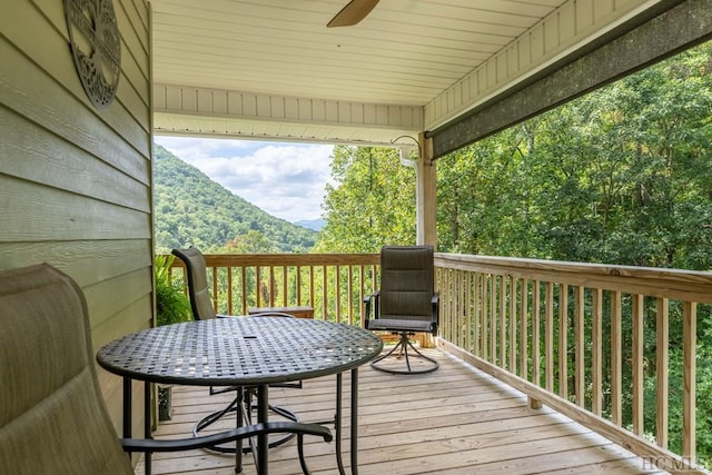 deck with a mountain view and ceiling fan