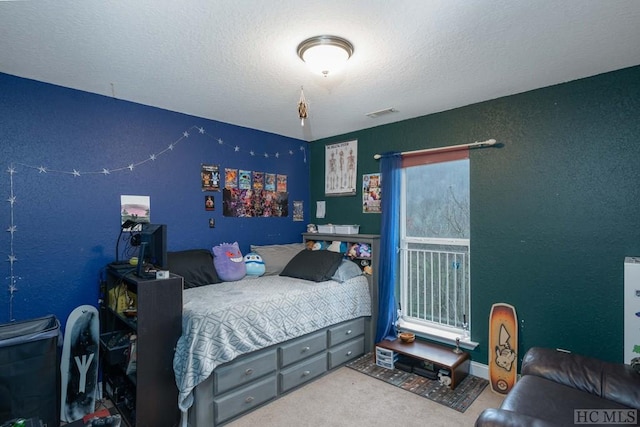 bedroom with carpet flooring and a textured ceiling