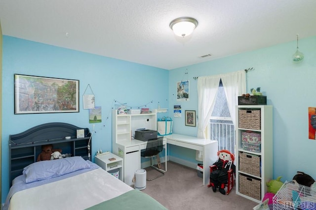 carpeted bedroom with a textured ceiling