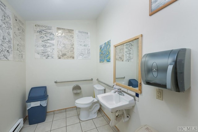 bathroom with tile patterned floors, baseboard heating, sink, toilet, and vaulted ceiling