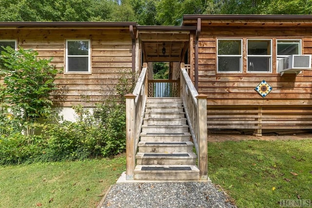 property entrance with a yard and cooling unit