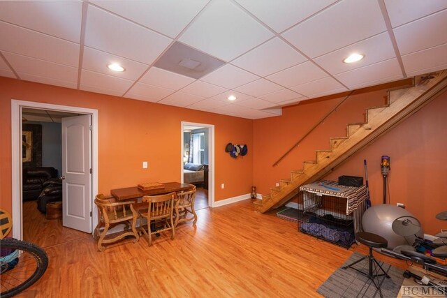 interior space featuring light wood-type flooring and a paneled ceiling