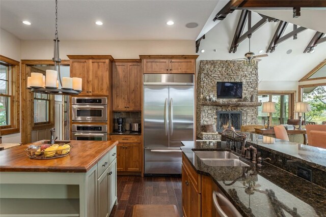 541 Summer Hill Rd, Cullowhee, NC 28723 - kitchen featuring stainless steel appliances, butcher block countertops, dark wood-type flooring, open floor plan, and brown cabinets