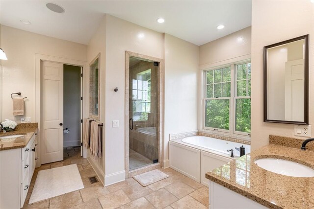 541 Summer Hill Rd, Cullowhee, NC 28723 - bathroom with two vanities, a stall shower, stone tile floors, a garden tub, and recessed lighting