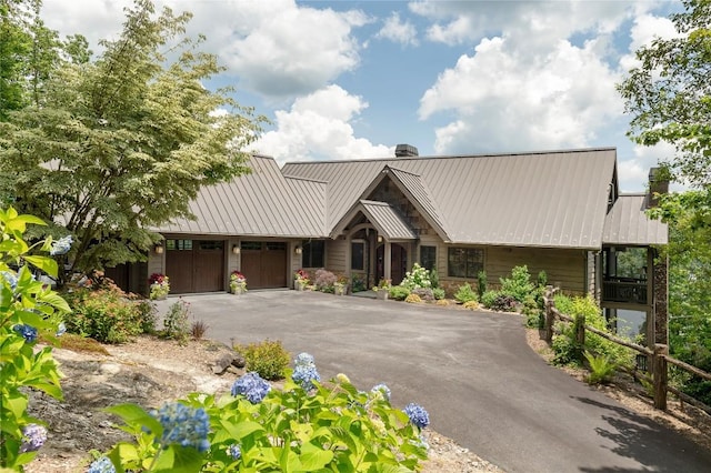 541 Summer Hill Rd, Cullowhee, NC 28723 - view of front of house featuring a chimney, asphalt driveway, an attached garage, stone siding, and a metal roof