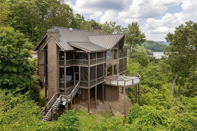 541 Summer Hill Rd, Cullowhee, NC 28723 - rear view of property with a sunroom, a standing seam roof, a chimney, stairs, and a metal roof