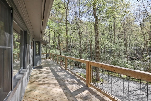 wooden deck featuring a wooded view