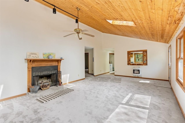 living area featuring heating unit, wood ceiling, and carpet flooring