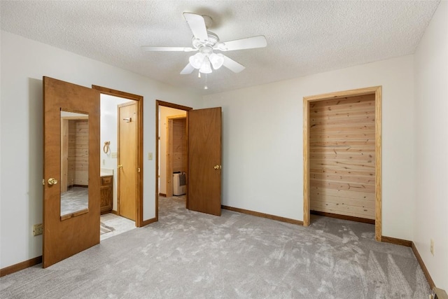 unfurnished bedroom featuring baseboards, a textured ceiling, and carpet