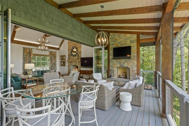 sunroom featuring beamed ceiling and a notable chandelier