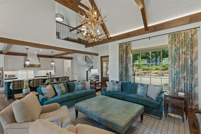 199 Springhead Trl, Cullowhee, NC 28723 - living room with beamed ceiling, stairway, a chandelier, wood finished floors, and high vaulted ceiling
