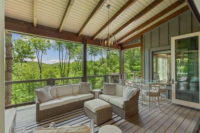 sunroom featuring beamed ceiling, a notable chandelier, an outdoor hangout area, and outdoor dining space