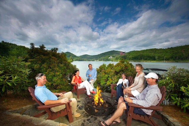 199 Springhead Trl, Cullowhee, NC 28723 - view of patio featuring a fire pit, a water view, and a forest view
