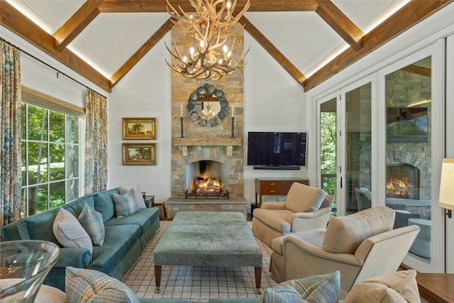 interior space with lofted ceiling with beams, a chandelier, a fireplace, and a healthy amount of sunlight