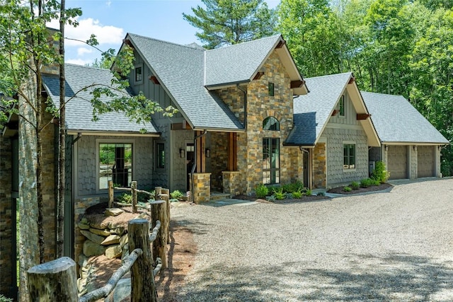 199 Springhead Trl, Cullowhee, NC 28723 - view of front of house featuring a shingled roof, stone siding, board and batten siding, driveway, and a garage