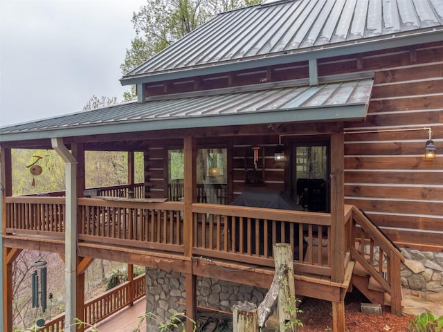 rear view of property featuring metal roof and a standing seam roof