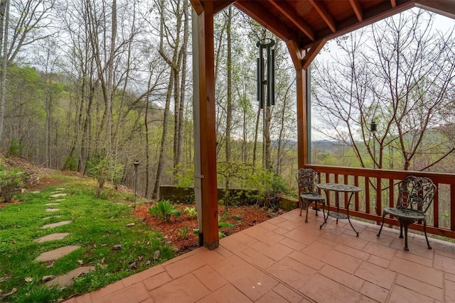 view of patio / terrace featuring a forest view