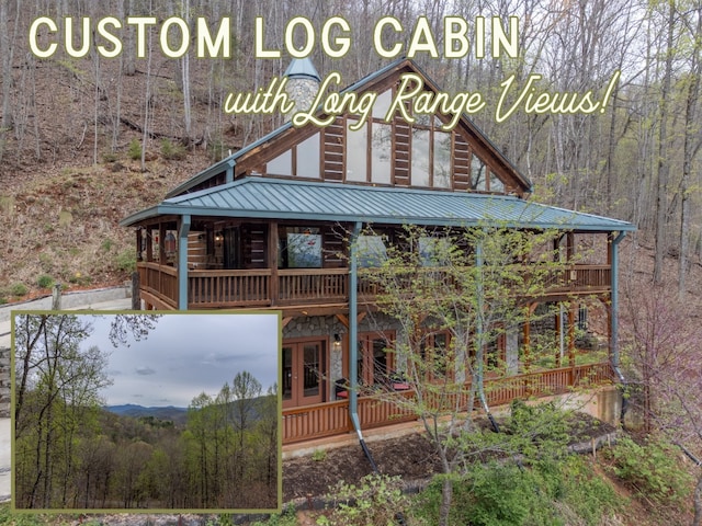 view of front facade featuring a wooded view, metal roof, french doors, and stone siding