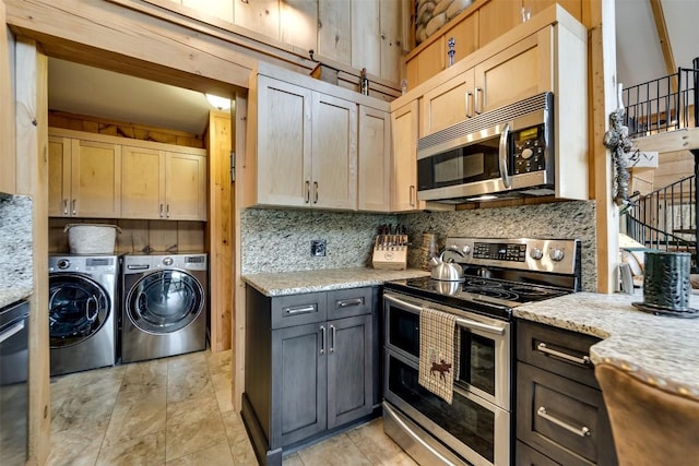 kitchen with light stone countertops, independent washer and dryer, tasteful backsplash, appliances with stainless steel finishes, and light brown cabinets