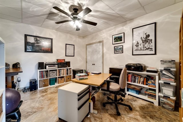 office featuring a paneled ceiling and a ceiling fan