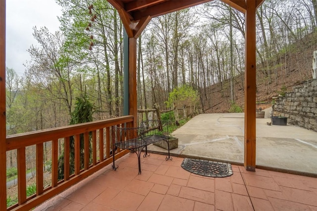 exterior space featuring a patio area and a forest view