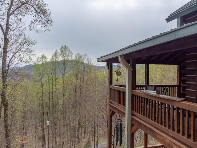 wooden terrace with a wooded view and a mountain view