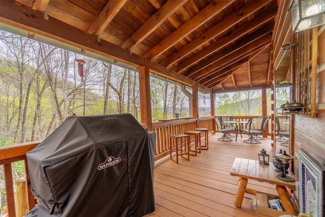 wooden deck with grilling area and outdoor dining area