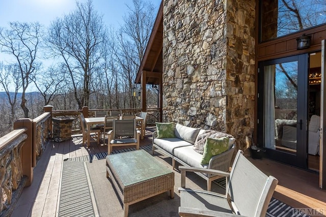 wooden deck with an outdoor hangout area and outdoor dining area