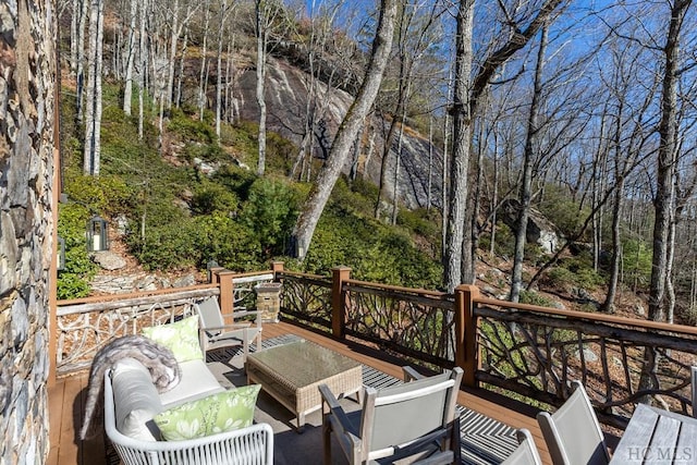 wooden terrace with an outdoor living space