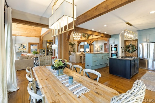 dining area featuring lofted ceiling with beams, hardwood / wood-style flooring, a notable chandelier, and recessed lighting