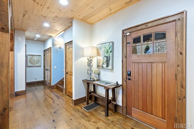 foyer featuring recessed lighting, wood ceiling, wood-type flooring, and baseboards