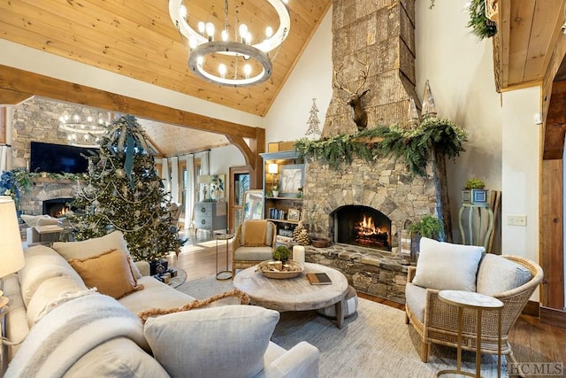 living room with a fireplace, high vaulted ceiling, a chandelier, and wood finished floors