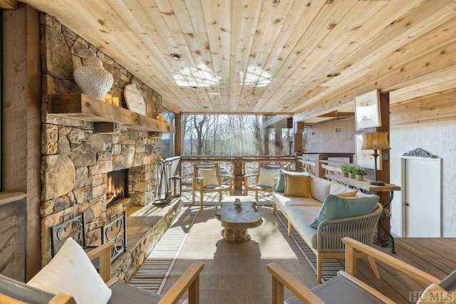 interior space with wood ceiling and an outdoor stone fireplace