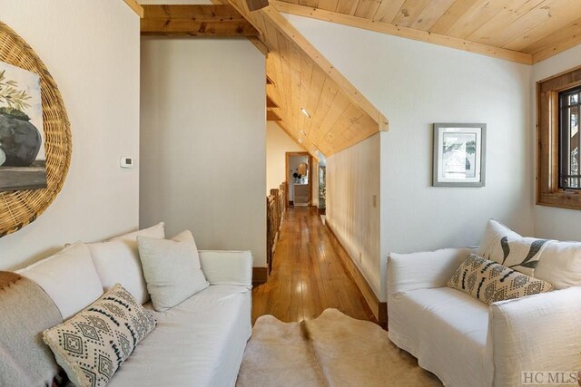 living room featuring wooden ceiling, lofted ceiling with beams, and wood finished floors